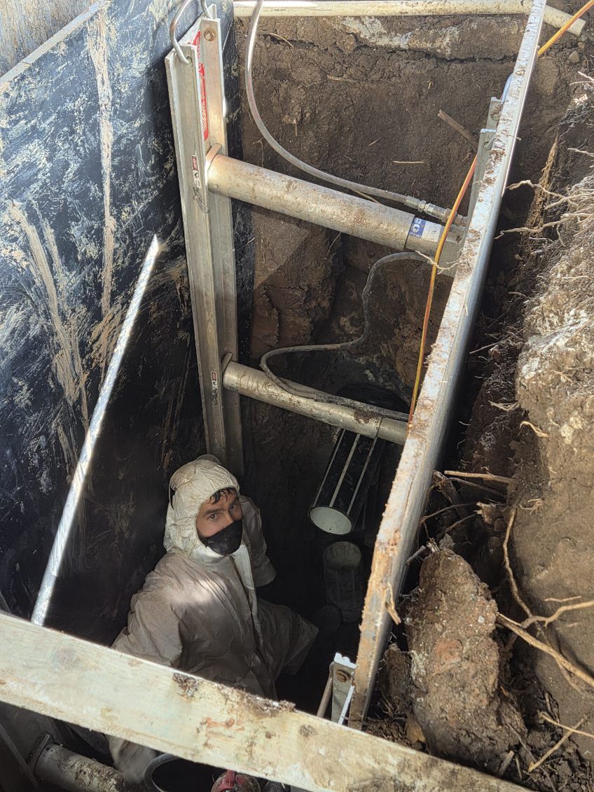 Invertex worker in full PPE inside a deep shored excavation pit